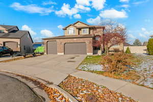 Traditional home featuring brick siding and driveway