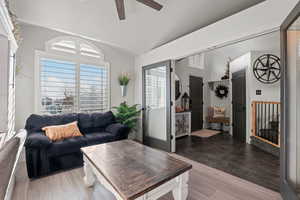Living area featuring lofted ceiling and ceiling fan