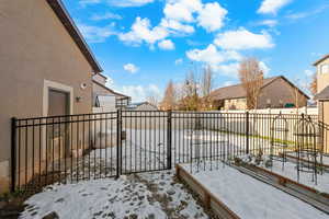 Fenced backyard featuring a residential view and a gate
