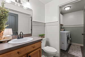 Bathroom with washer and dryer and vanity