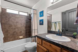 Bathroom with vanity and shower / tub combo