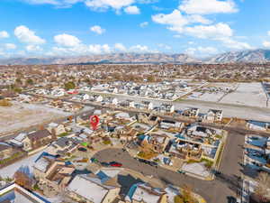 Aerial overview of property's location with nearby suburban area and a mountainous background