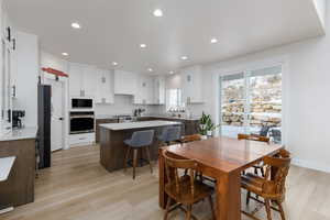 Dining area featuring recessed lighting and light wood finished floors