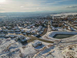 Snowy aerial view featuring a residential view and a mountain view
