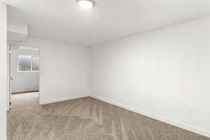Unfurnished room with carpet and baseboards