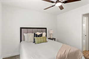 Bedroom with a ceiling fan and baseboards