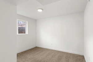 Carpeted empty room with baseboards