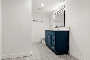 Bathroom with vanity and recessed lighting