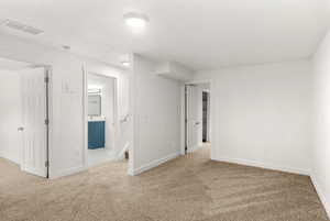 Empty room featuring carpet and baseboards