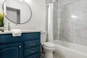 Full bath featuring vanity and shower / bathtub combination with curtain