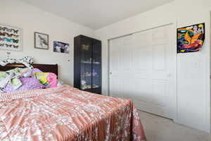 Bedroom featuring a light colored carpet