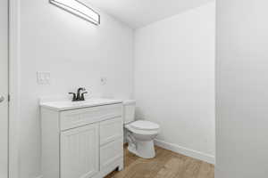 Jack n Jill bathroom with vanity and light wood-style flooring