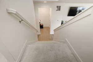 Staircase featuring baseboards and recessed lighting