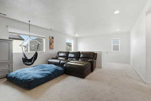 Living room featuring carpet, healthy amount of natural light, and recessed lighting