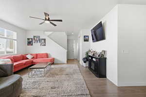 Living room with ceiling fan and hardwood floors