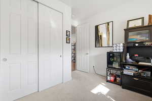 Bedroom featuring a closet and light colored carpet