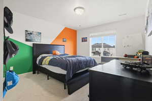 Bedroom featuring light colored carpet