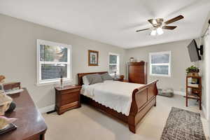 Bedroom featuring light colored carpet and ceiling fan