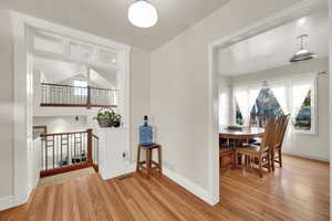 Dining area with light wood-type flooring and lofted ceiling