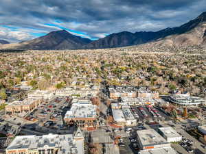 Aerial view of property and surrounding area with a mountain backdrop