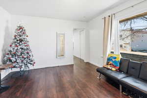 Sitting room featuring baseboards and dark wood-style flooring
