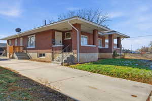 View of front of house featuring brick siding and a front yard