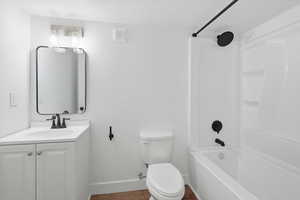 Full bath with shower / washtub combination, vanity, and a textured ceiling