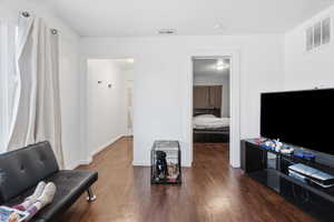 Living area with dark wood finished floors and baseboards
