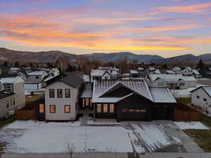 View of front of home featuring a residential view, board and batten siding, a mountain view, an attached garage, and concrete driveway