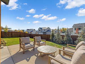 Fenced backyard featuring a residential view, a patio area, and outdoor lounge area