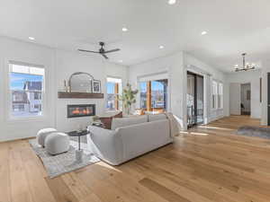 Living room featuring a ceiling fan, plenty of natural light, light wood finished floors, and recessed lighting