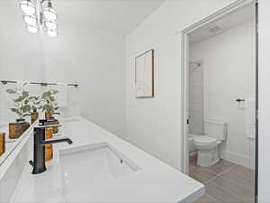 Full bathroom with double vanity and light tile patterned flooring