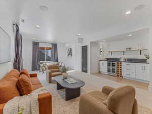 Living room with wet bar, wine cooler, and recessed lighting