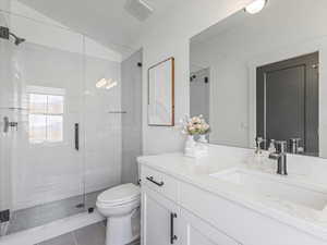 Full bathroom with vanity, a stall shower, and tile patterned flooring