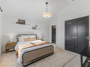 Bedroom featuring lofted ceiling, a closet, and light colored carpet