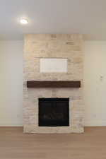 Detailed view of a fireplace and wood finished floors