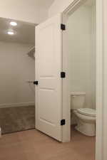 Bathroom featuring recessed lighting, light wood-type flooring, and a walk in closet