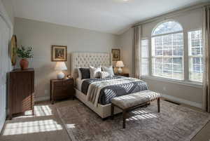 Carpeted bedroom featuring vaulted ceiling and baseboards