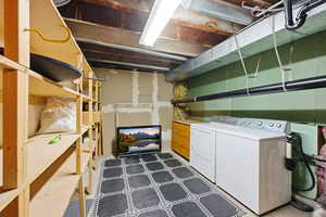 Washroom with washing machine and dryer built in shelving