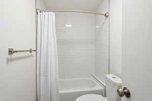 ALL NEW Bathroom featuring toilet and shower / tub combo