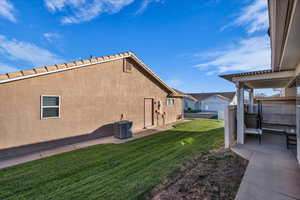 View of side of home featuring stucco siding and a patio
