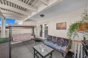 View of patio featuring french doors and an outdoor living space