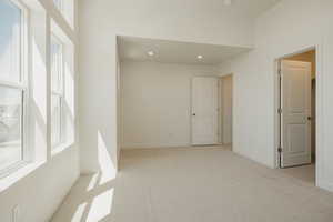 Empty room featuring light colored carpet and recessed lighting