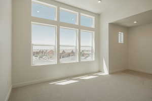 Unfurnished room featuring light colored carpet and recessed lighting