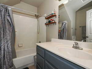 Full bath featuring shower / bath combo and vanity