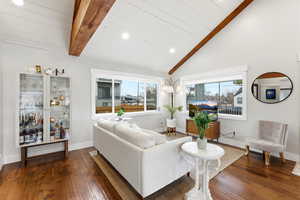 Living area featuring recessed lighting and dark wood-style flooring
