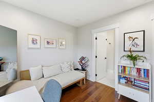 Living area with wood finished floors and baseboards