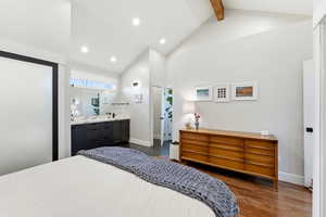 Bedroom with dark wood finished floors, beam ceiling, recessed lighting, and high vaulted ceiling