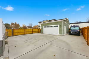 Garage featuring concrete driveway