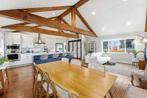 Dining area with light wood-style floors, wooden ceiling, and recessed lighting